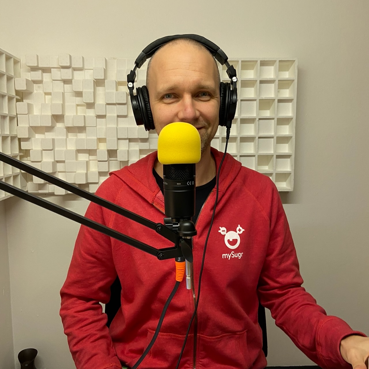 Milan in a red mySugr hoodie, recording a podcast